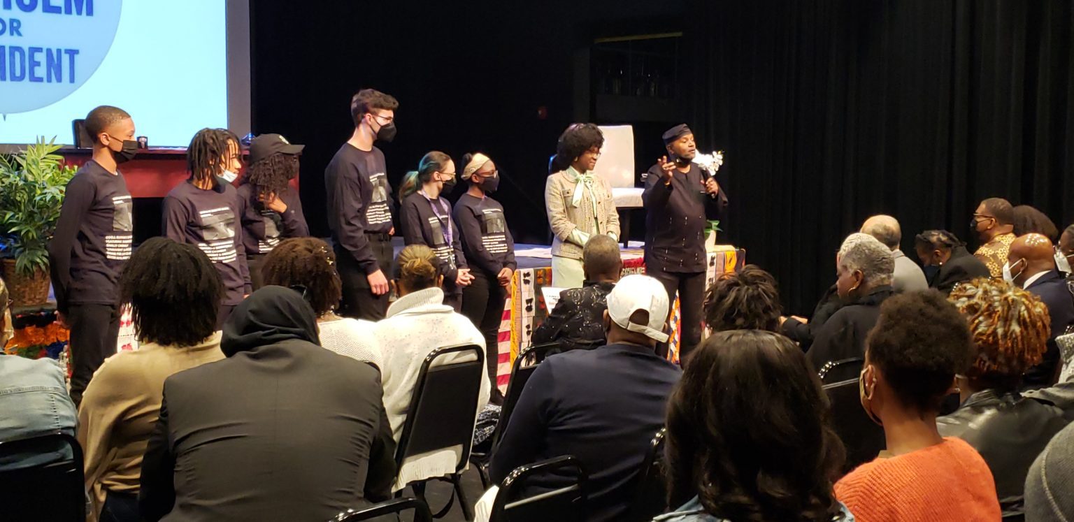 A group of people standing in front of a microphone.