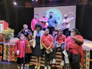 A group of people dressed in pink and red.