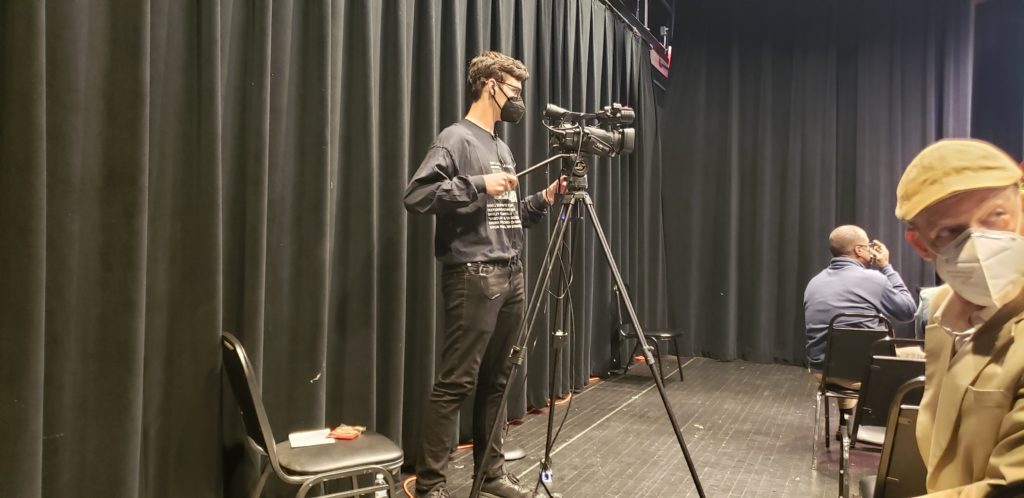 A man standing in front of a camera.