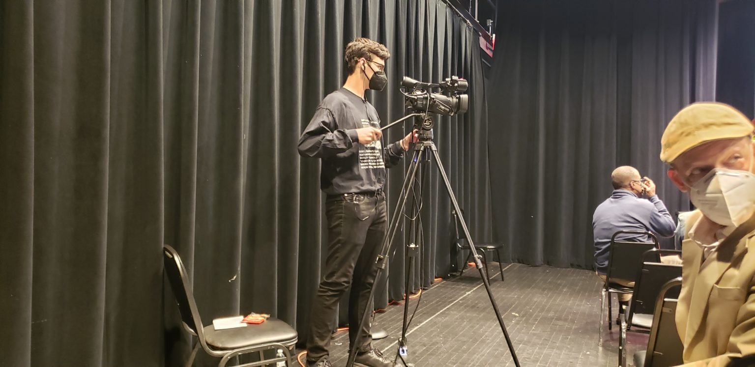A man standing in front of a camera.