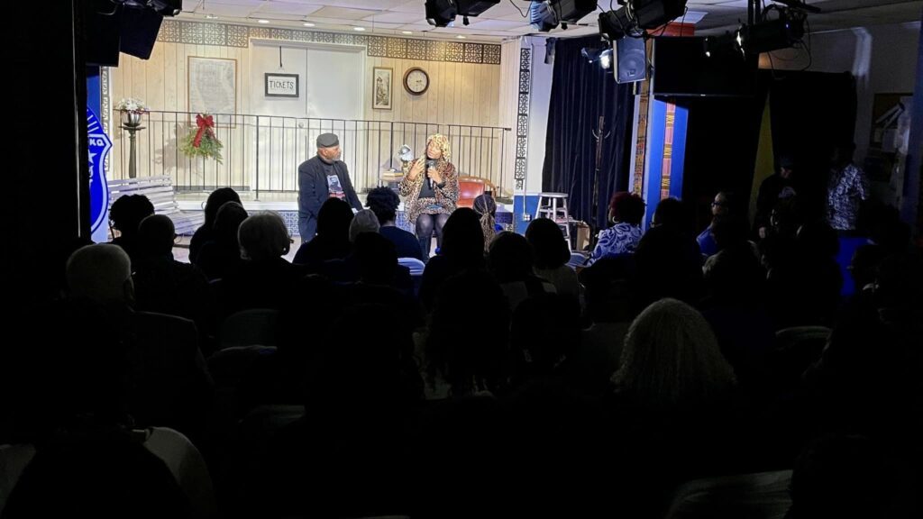 A group of people sitting in front of a crowd.
