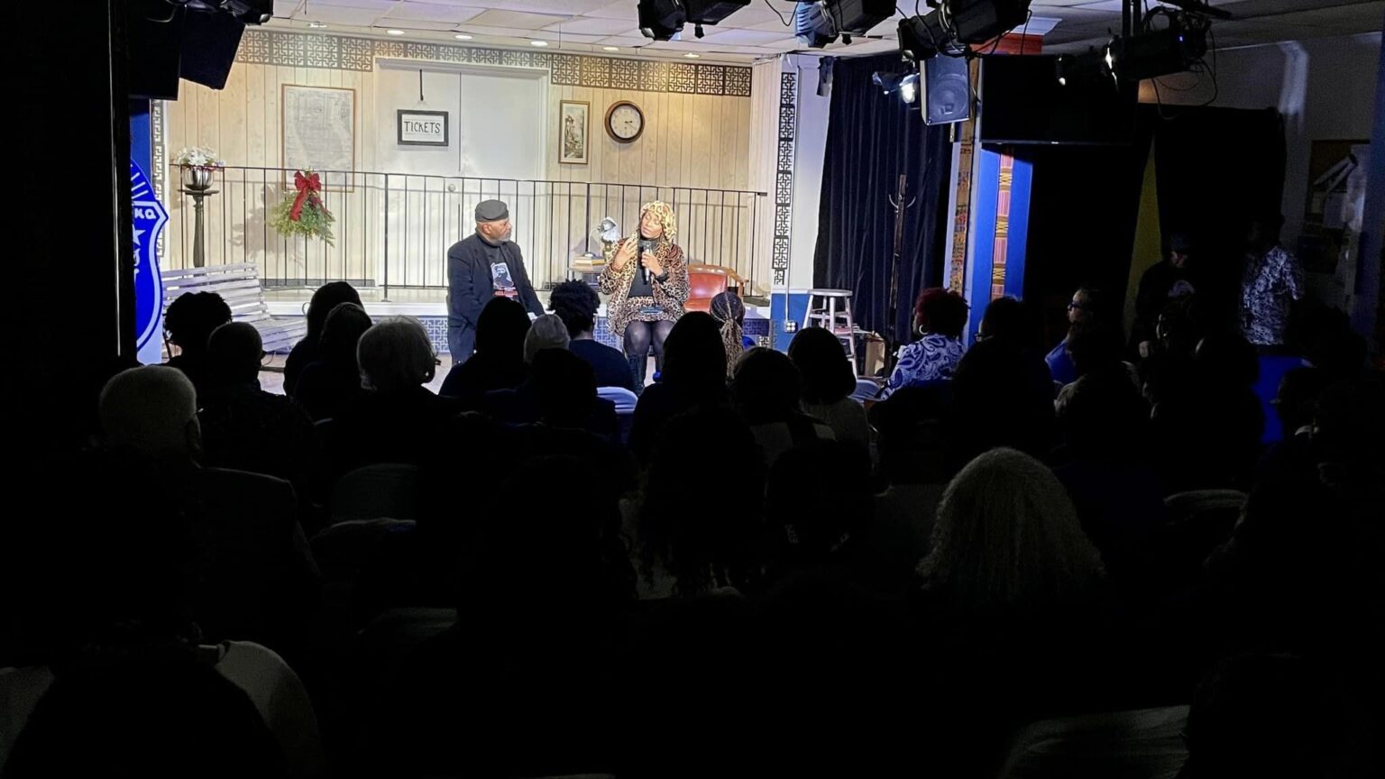 A group of people sitting in front of a crowd.