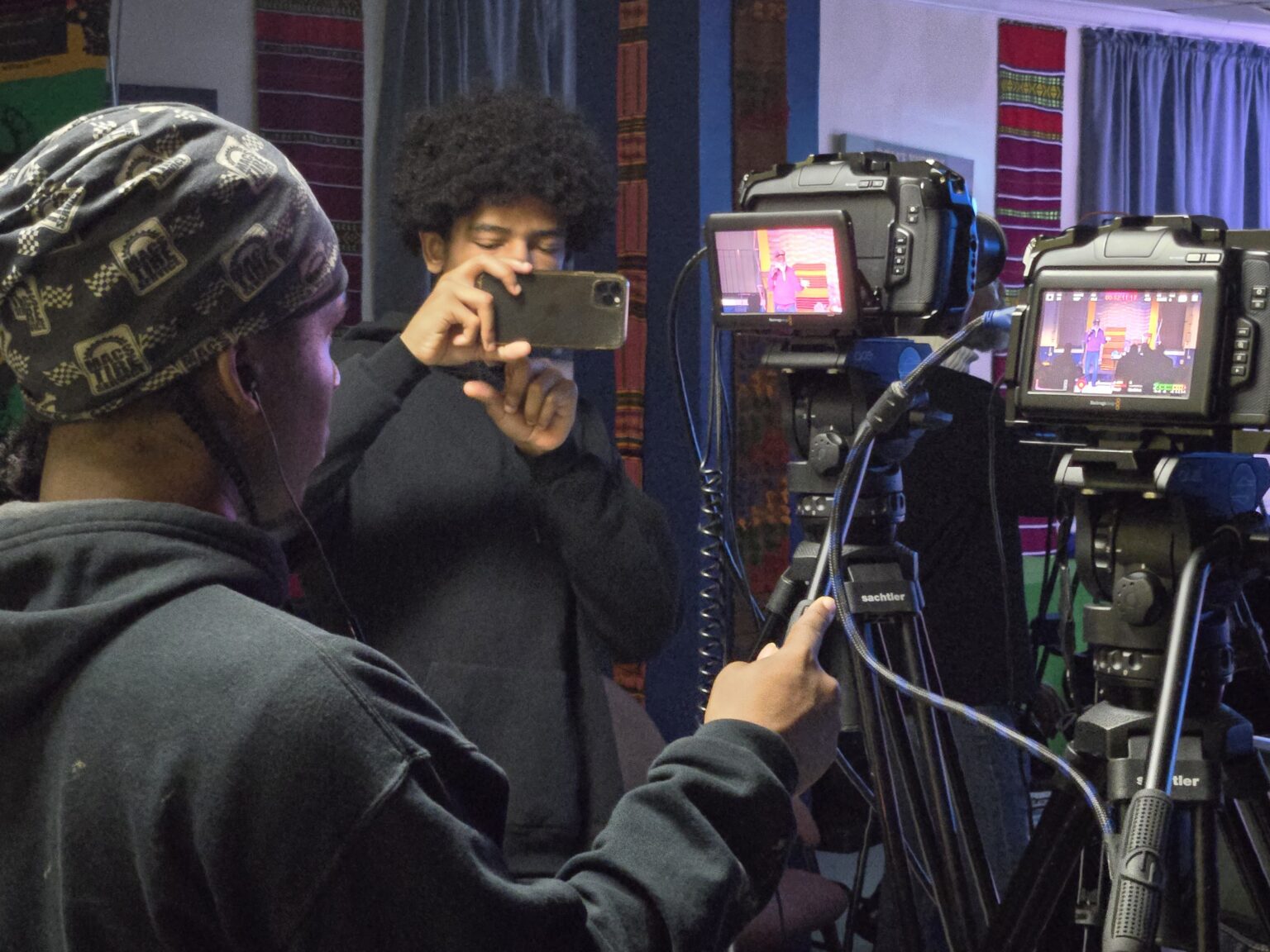 MMTI students ages 16–24 handling professional video cameras during digital literacy training in Washington DC
