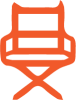 An orange chair is sitting in front of a black background.